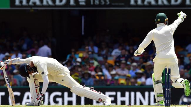 England's batsman Moeen Ali (L) is stumped by Australia's wicketkeeper Tim Paine.