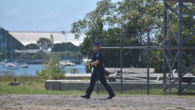 Police investigate the scene on the banks of the Burnett River and interview boaties following a serious boat crash.