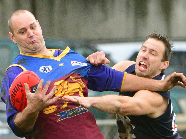 NFL footy: Epping V South Morang. Ben Taylor-Egan marks for South Morang against Epping's Peter McMahon.