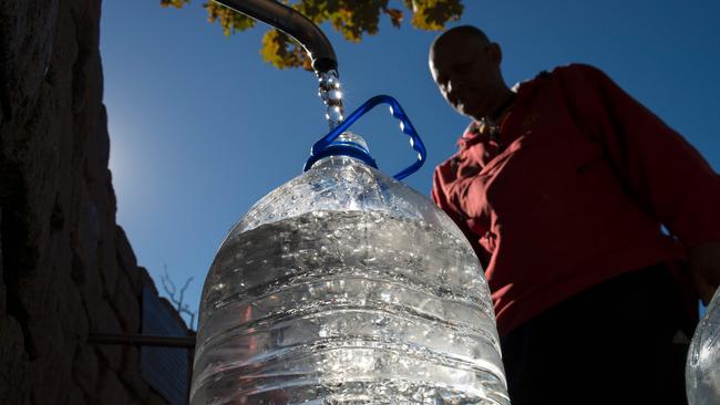 A man collects drinking water from taps that are fed by a spring in Cape Town. South Africa's Western Cape region which includes Cape Town declared a drought disaster on May 22, 2017. Picture: Rodger Bosch