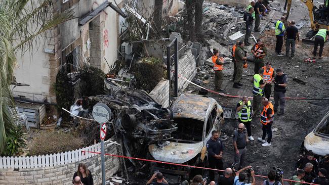 First responders and Israeli security forces gather after a missile attack on Kiryat Bialik in the Haifa district. Picture: AFP