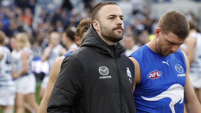 GEELONG, AUSTRALIA - JULY 09: Griffin Logue and Aidan Corr of the Kangaroos walk from the ground after during the round 17 AFL match between Geelong Cats and North Melbourne Kangaroos at GMHBA Stadium, on July 09, 2023, in Geelong, Australia. (Photo by Darrian Traynor/Getty Images)