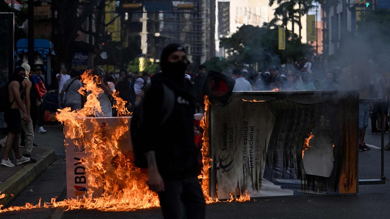 Demonstrators set a barricade on fire during a protest against Venezuelan President Nicolas Maduro's government in Caracas. Picture: JUAN BARRETO / AFP