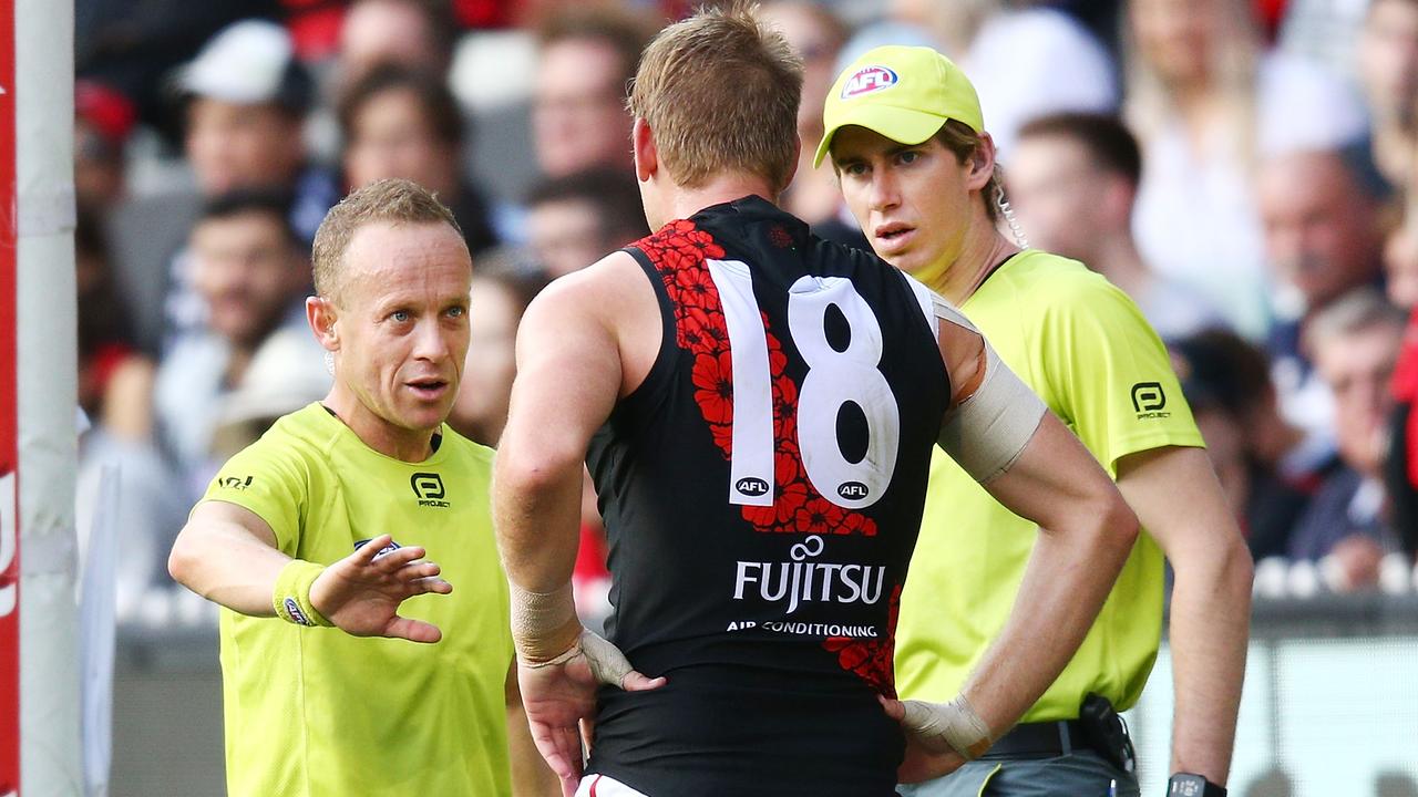 Umpire Ray Chamberlain speaks with Essendon’s Michael Hurley. (Photo by Michael Dodge/Getty Images)