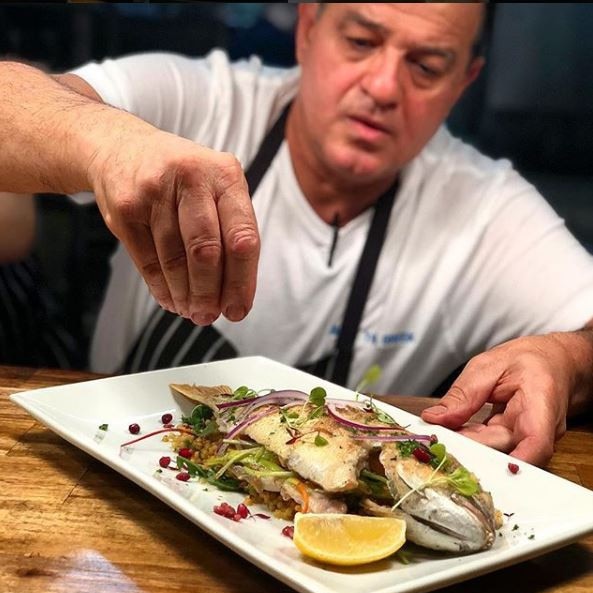 Preparing a snapper at Billy The Greek at Dural.