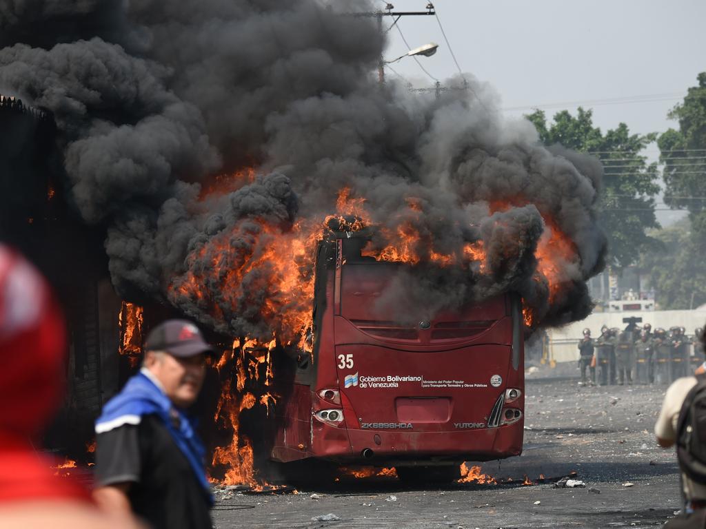 A bus burns down during a protest after a temporary close-down of the border with Colombia after Venezuelan president Maduro blocked aid. Picture: AFP