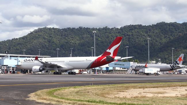 A Qantas Airbus A330 and a Jetstar Airbus A320 wide body passenger jet aircraft sit on the tarmac at the Cairns Airport international terminal. Picture: Brendan Radke