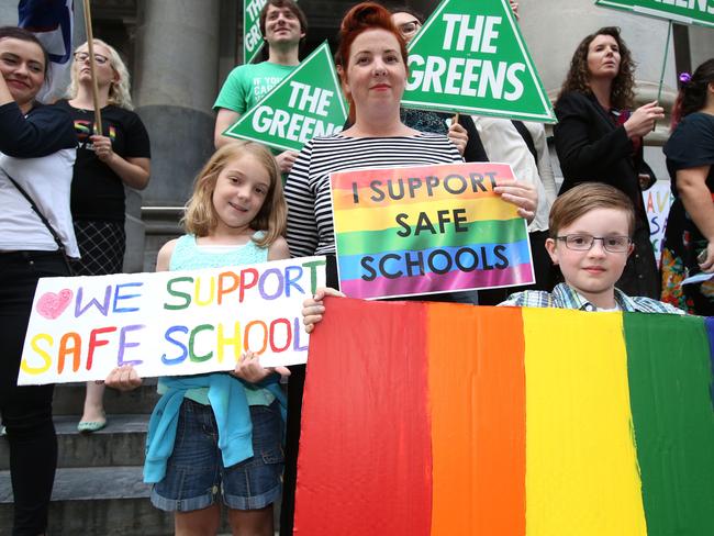 Melissa Murray and her children Ella, nine, and Noah, eight, rally at Parliament House. Picture: Stephen Laffer