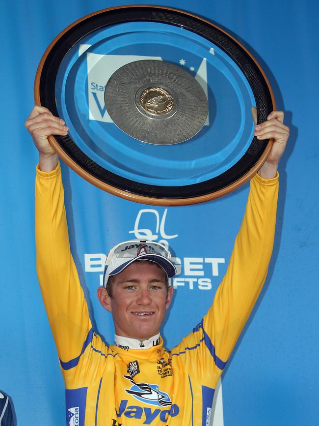 2013 Herald Sun Tour winner Calvin Watson holds the trophy aloft after winning stage 3 from Moonah Links to Arthurs Seat.
