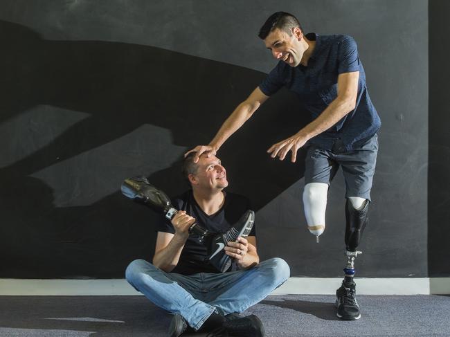 Mike Rolls, pictured with Blank Canvas founder Doug Hartmann, has two bionic legs and is using his experience to inspire others. Pictures: Valeriu Campan