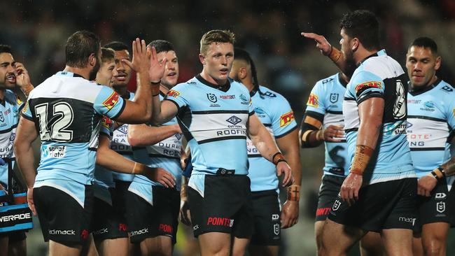 Sharks players congratulate Jack Williams after he scored his controversial try.