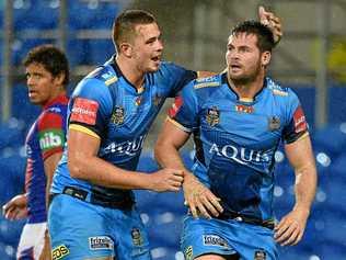 Titans player Nathan Davis congratulates Anthony Don (right) after he scored a try during the Round 1 NRL match between the Gold Coast Titans and the Newcastle Knights at CBUS Stadium on the Gold Coast. Picture: DAVE HUNT