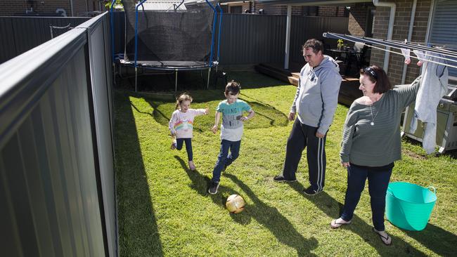 Phil and Sarah Powrie with their kids Imogen, 4 and Eli, 8, is glad they’re in the market. Picture: Dylan Robinson