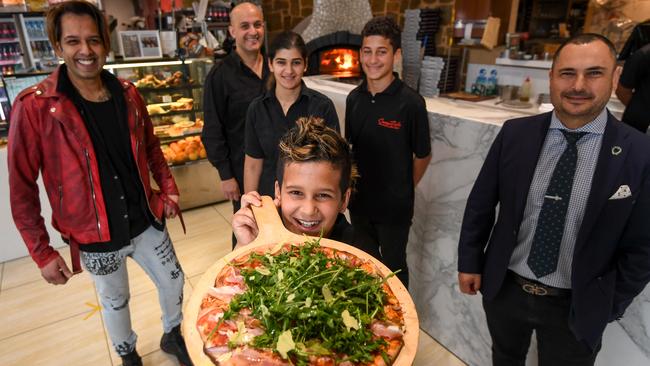 Pizza maker Freddy Kerbage (back) with Inas, Maurice, 12, and Zane, 10 (front) have teamed up with hair stylist Deen Mos (L) and O’Brien Real Estate Chelsea director Stavros Ambatzidis to deliver free food to people who are struggling due to COVID-19 and lockdown. Picture: Penny Stephens