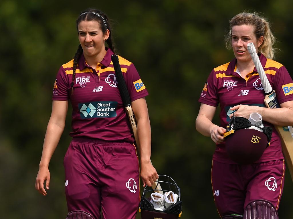 GOLD COAST, AUSTRALIA - OCTOBER 03: Charli Knott and Georgia Redmayne of Queensland leave the field after scoring the match winning runs during the WNCL match between Queensland and the Australian Capital Territory at Bill Pippen Oval, on October 03, 2022, in Gold Coast, Australia. (Photo by Albert Perez/Getty Images)