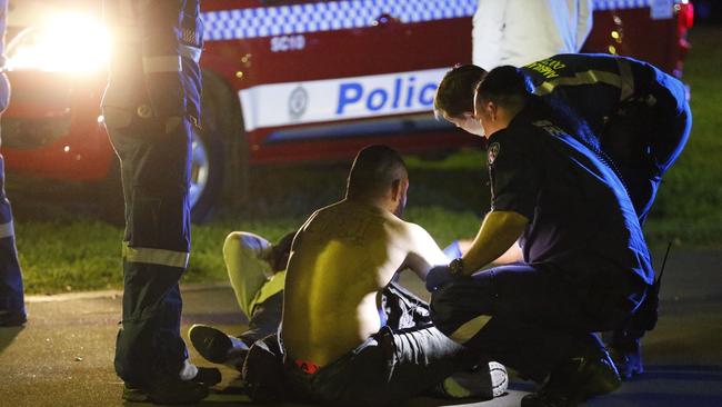 A man is treated by paramedics after the alleged brawl. Picture: Steve Tyson