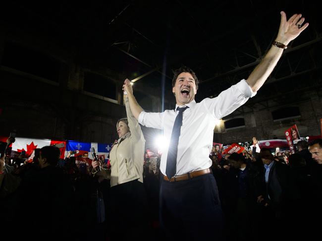 Liberal leader Justin Trudeau holds up the hand of candidate Genevieve Hinse during a rally in Montreal, Thursday Oct. 17, 2019. (Sean Kilpatrick/The Canadian Press via AP)