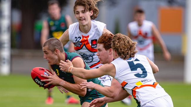 Oliver Davies tries to escape three Calder opponents. Picture: Linda Higginson