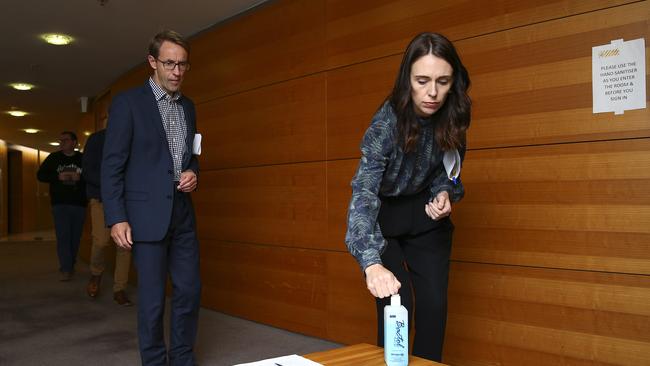 Jacinda Ardern and Director-General of Health Ashley Bloomfield on their way into a press conference at Parliament in Wellington on Sunday. Picture: Getty Images