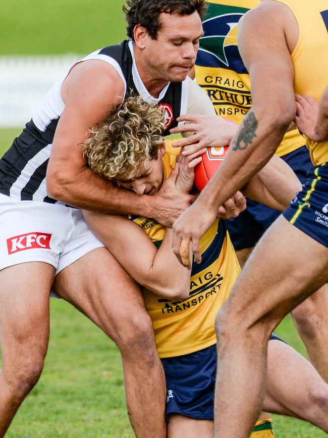 Eagles debutant Connor McLeod cops a high tackle from Port Adelaide’s Steven Motlop. Picture: Brenton Edwards