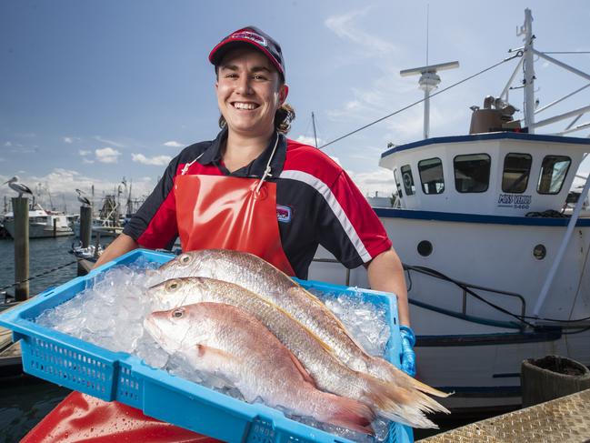 21 year old Fishmonger Dean Currie from Fiesheries on the Spit with fresh snapper at Mooloolaba Wharf. No Credit