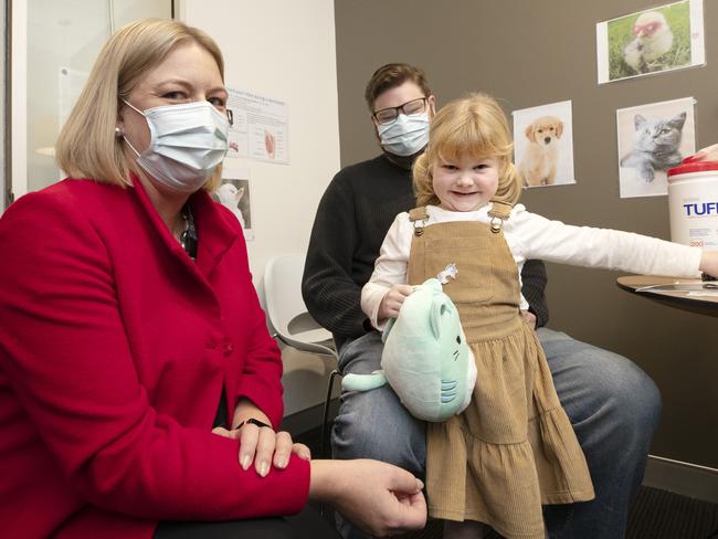 Secretary and Head of Agency at Department of Health Tasmania Kathrine Morgan- Wicks, Evelyn Williams 11 grabs a Chupa Chups after receiving her flu vaccination with her dad Thomas at Collins Street, Hobart. Picture: Chris Kidd