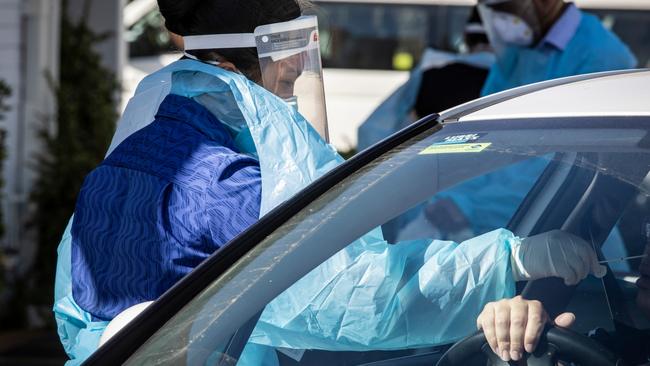 PERTH, AUSTRALIA  - NewsWire Photos FEBRUARY 2, 2021: Medicos attend to people at the Orrong Road the site of a drive through test facility asPerth starts its second day of a 5 day lockdown after a man tested positive to Covid 19. NCA NewsWire / Tony McDonough