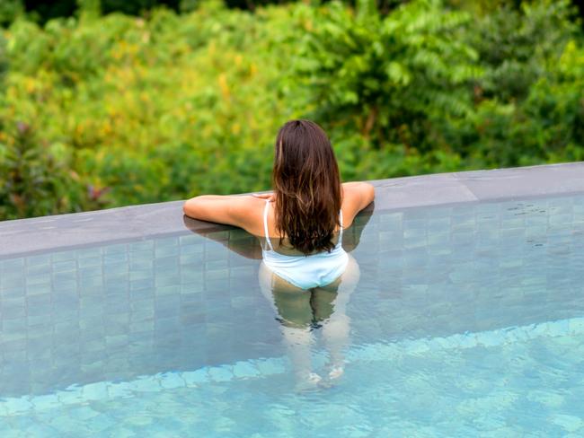 ESCAPE:  Beautiful woman relaxing on her vacations in the swimming pool and looking at the view  Picture: Istock