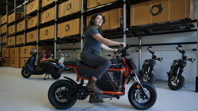 FONZ founder Michelle Nazzari pictured on an NKD electric motorcyle at her new carbon neutral warehouse in Alexandria. Picture: Britta Campion