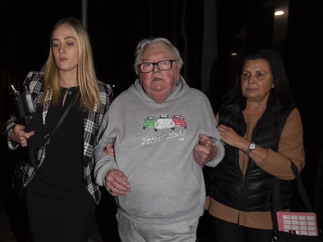 Former swim coach Dick Caine pictured leaving Bankstown Police Station with his wife (right) &amp; lawyer (left) on June 22. Picture: Monique Harmer