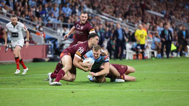 QLD'•s Xavier Coates tackles NSWÃ's Tom Trbojevic.  Queensland vs New South Wales for game 2 of the State of Origin Series at Suncorp Stadium.  Pic Peter Wallis