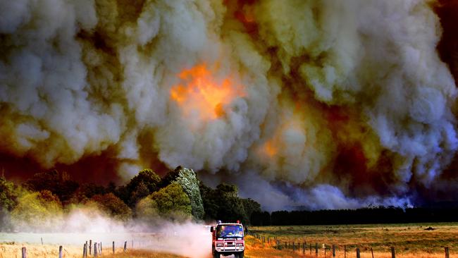 Raging inferno: Firefighters outrun the Labertouche bushfire. Picture: Alex Coppel