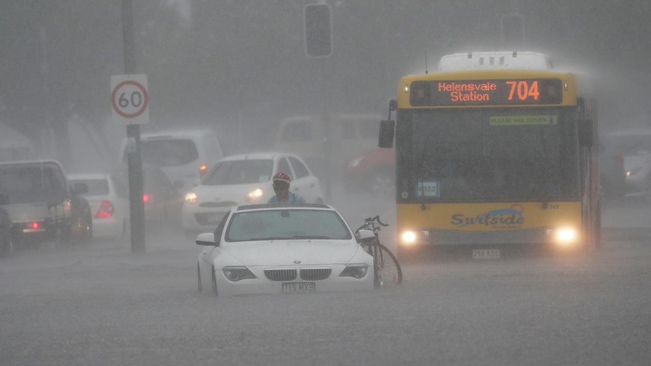 A car is flooded on Queen St in Southport after a storm lashes the Gold Coast. Photograph : Jason O’Brien