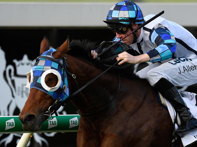 John Allen rides Kenedna to victory in the Doomben Cup. Picture: AAP