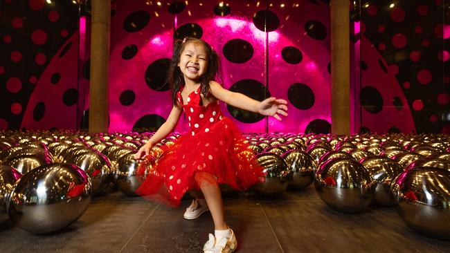 Ava Bandara, 4, checks out the Narcissus Garden by Yayoi Kusama in the NGV foyer. Picture: Mark Stewart