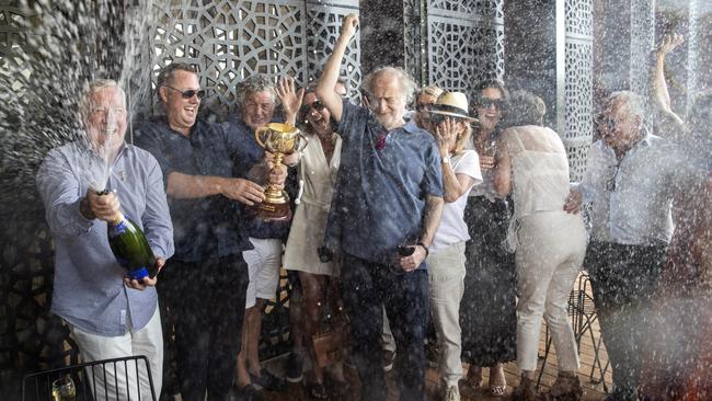 Gerry Ryan, left, Nick Williams, second from left, and Michael Gudinski, centre, celebrate in St Kilda. Picture: Aaron Francis