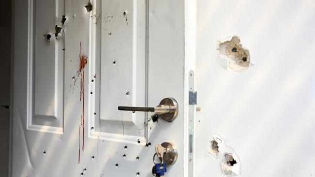 Bullet-riddled door of a house at Kfar Aza, Israel