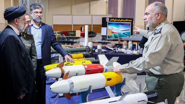 Former Iranian president Ebrahim Raisi (L) is shown the Almas guided weapons and drones similar to America's armed MQ-9 Reaper drone. Picture: Image: Iranian Presidency via Alamy.