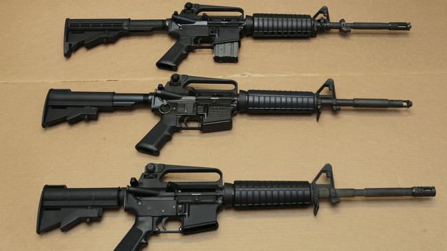 Three variations of the AR-15 assault rifle are displayed at the California Department of Justice in Sacramento. While the guns look similar, the bottom version is illegal in California because of its quick reload capabilities. Picture: Rich Pedroncelli