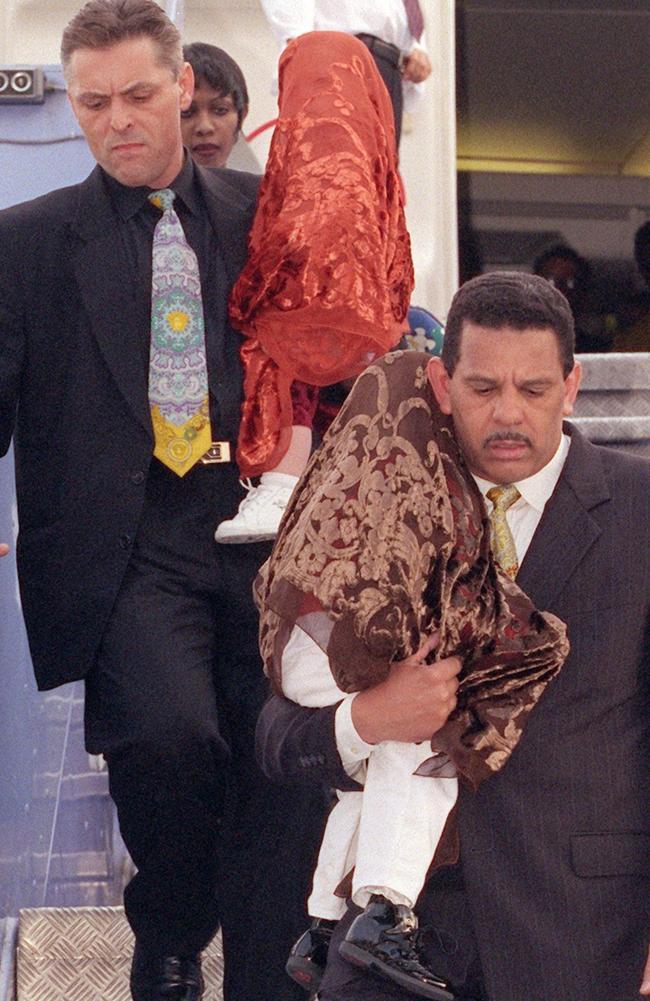 The two eldest Jackson children are carried off a plane in 1999. 