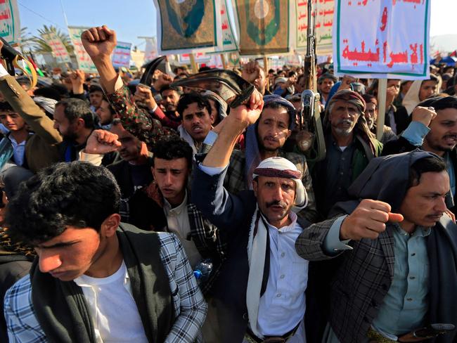 Yemenis wave flags and hold placards during a demonstration denouncing Israeli stikes and in solidarity with Palestine in the Huthi-controlled capital Sanaa on December 27, 2024. Huge crowds demonstrated in Yemen's capital on December 27, a day after Israeli jets pounded Huthi rebel targets in response to missile and drone attacks by the Iran-backed group. (Photo by Mohammed HUWAIS / AFP)