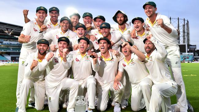 Australia's captain Tim Paine holds the Ashes Urn as the players celebrate victory after the presentation ceremony on the fourth day of the fifth Ashes cricket Test match between England and Australia at The Oval.