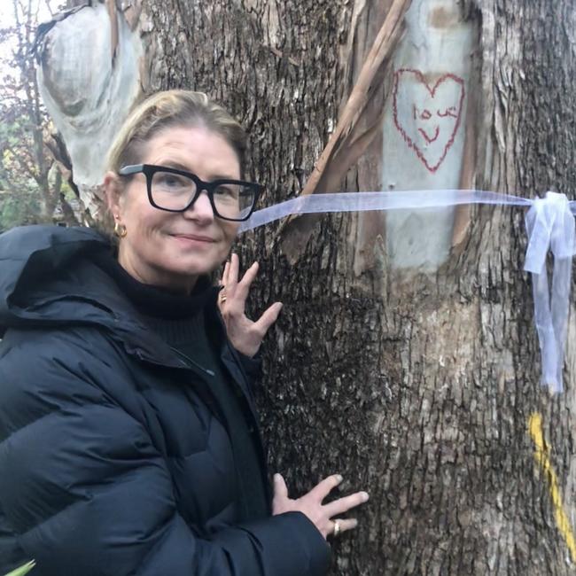 Resident Arabella Lockhart with one of the trees identified for removal in Ruskin Rowe. Picture: Jim O’Rourke