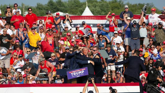 The scene at the rally just after Donald Trump, centre, was grazed by a bullet. Picture: AFP