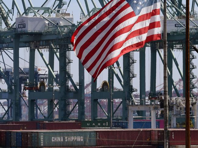 The US flag flies over Chinese shipping containers unloaded at the Port of Long Beach, in Los Angeles County. Picture: AFP