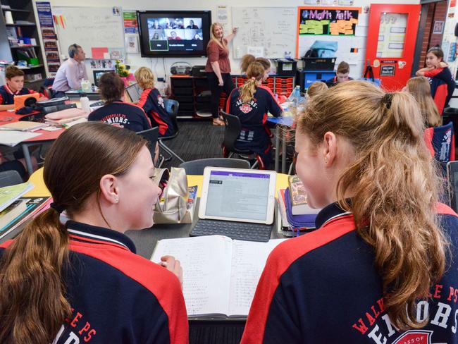 Walkerville Primary students back at school, April 27, 2020. Year 7 teacher Kristan Gilbert (0403747255) teaching her class, with students  Ruby Morris and Sophia Joyce. (Pic: AAP/Brenton Edwards)