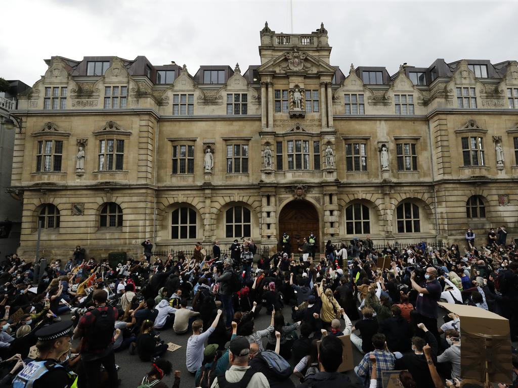 Protesters outside Oxford University with the statue of Cecil Rhodes above.