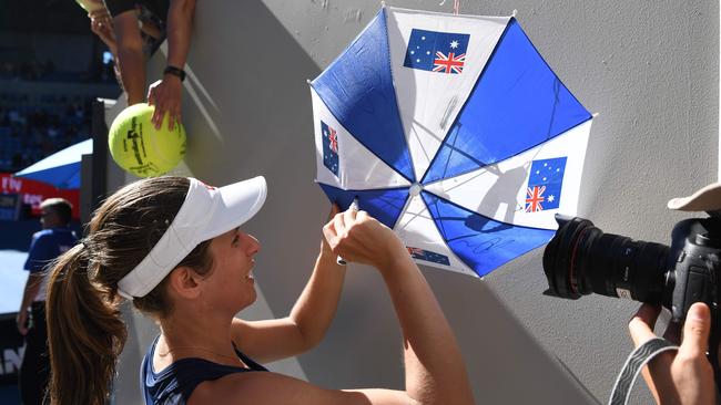 Johanna Konta was happy to sign this Aussie memorabilia. Picture: AFP