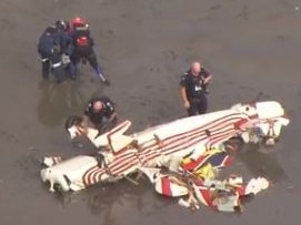 Emergency crews on the scene of a plane crash off Bribie Island. Photo: 7 News Brisbane