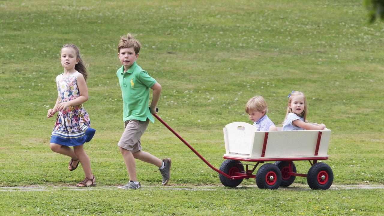 Prince Christian and Princess Isabella pull their brother and sister along while playing at Grasten Palace. Picture: Julian Parker/UK Press via Getty Images